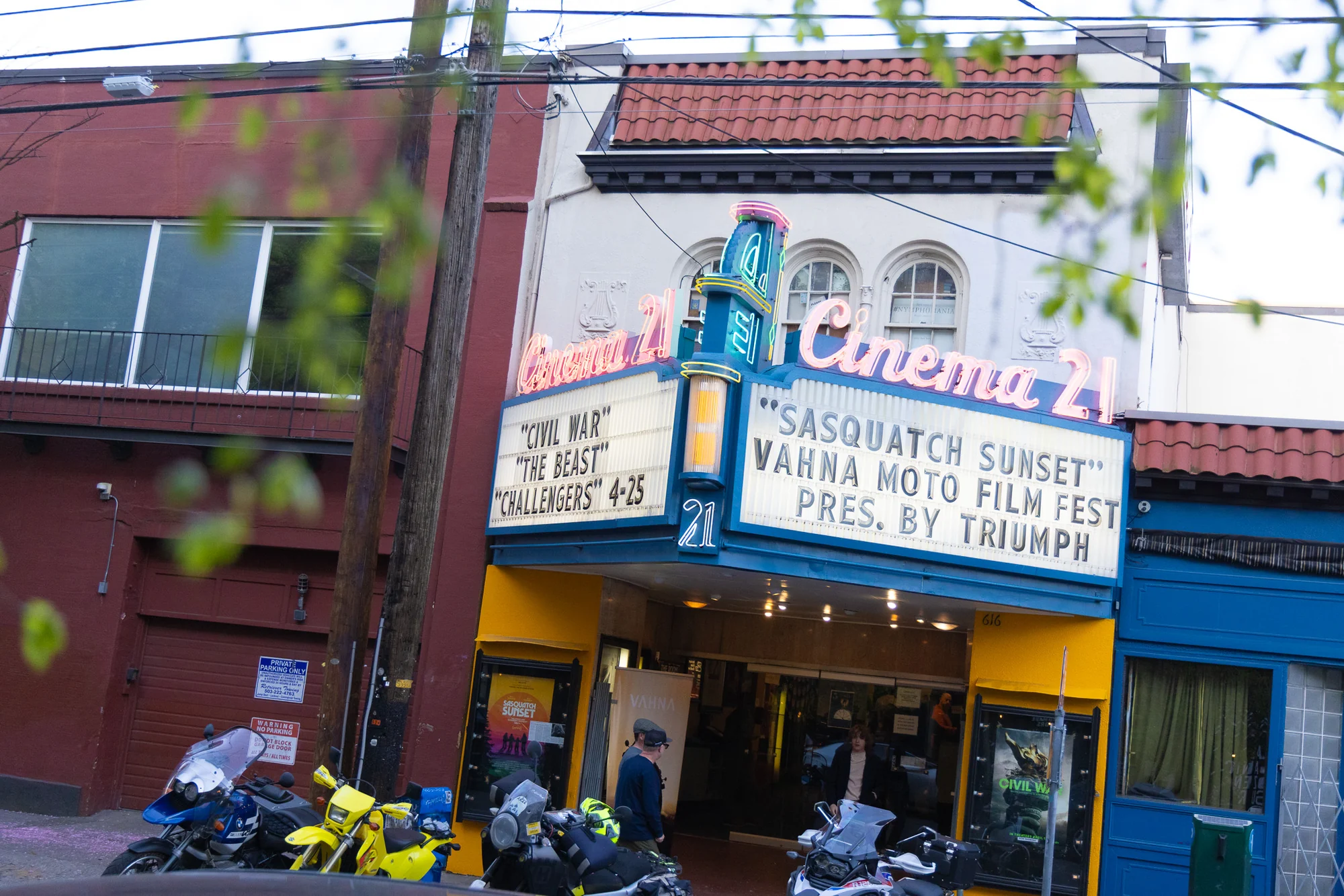 Cinema 21 exterior in Portland with motorcycles parked beneath the VAHNA Film Festival marquee.