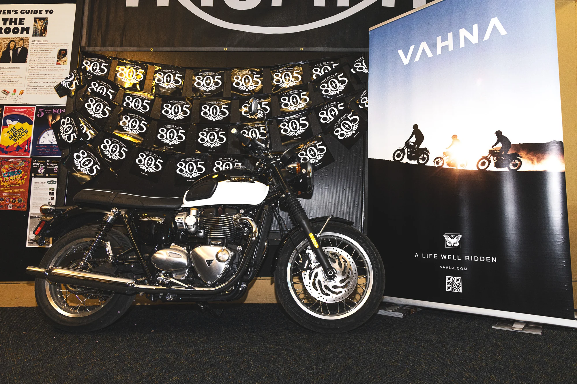 Motorcycle displayed inside the cinema beside a VAHNA festival banner.