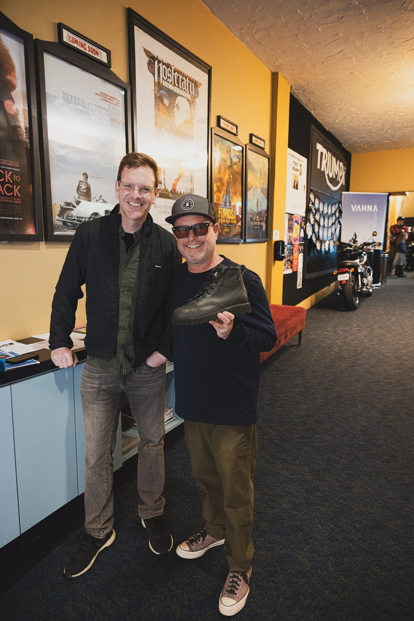 Two festival attendees posing together in the cinema hallway.