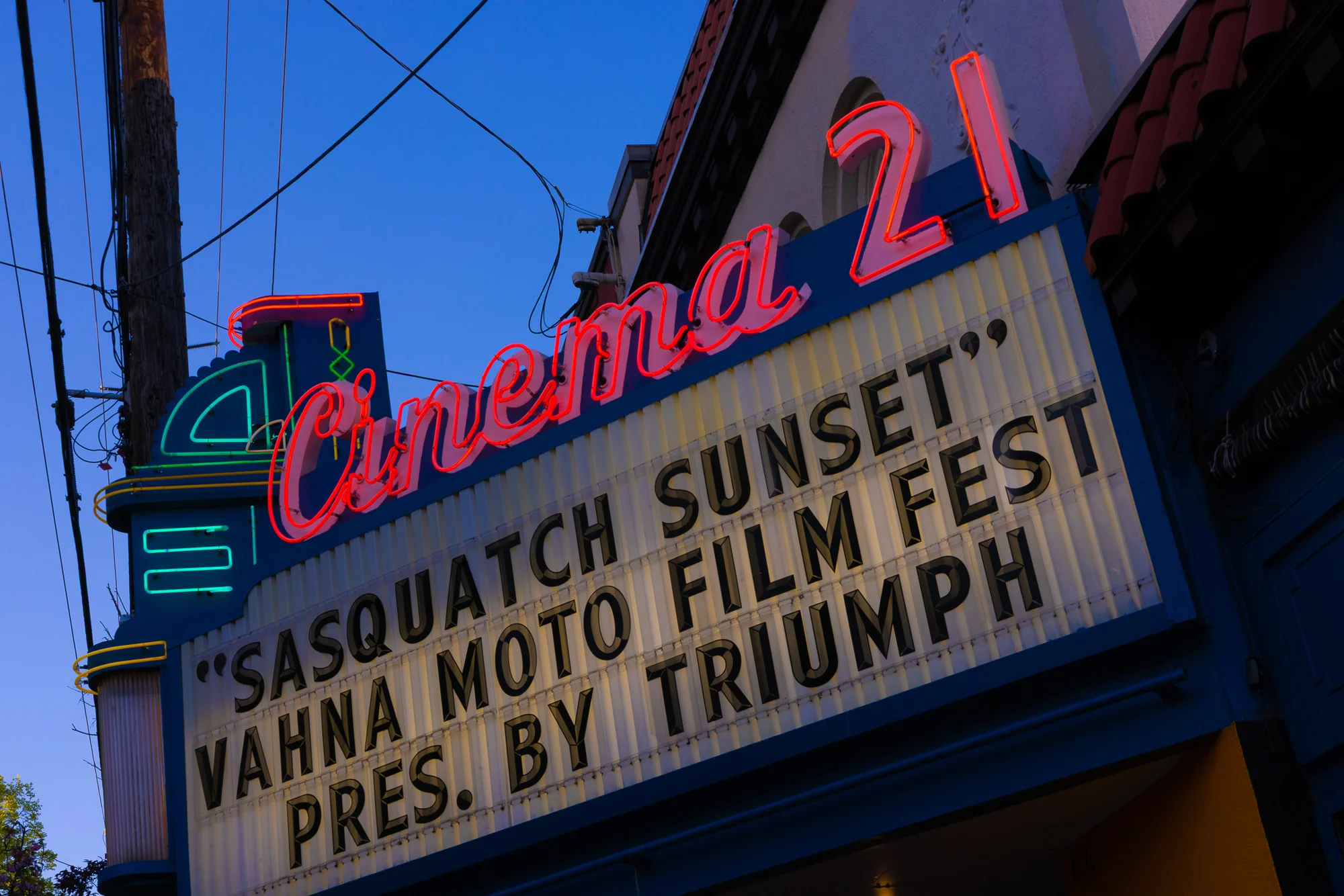 Cinema 21 neon and marquee announcing the VAHNA Motorcycle Film Festival.
